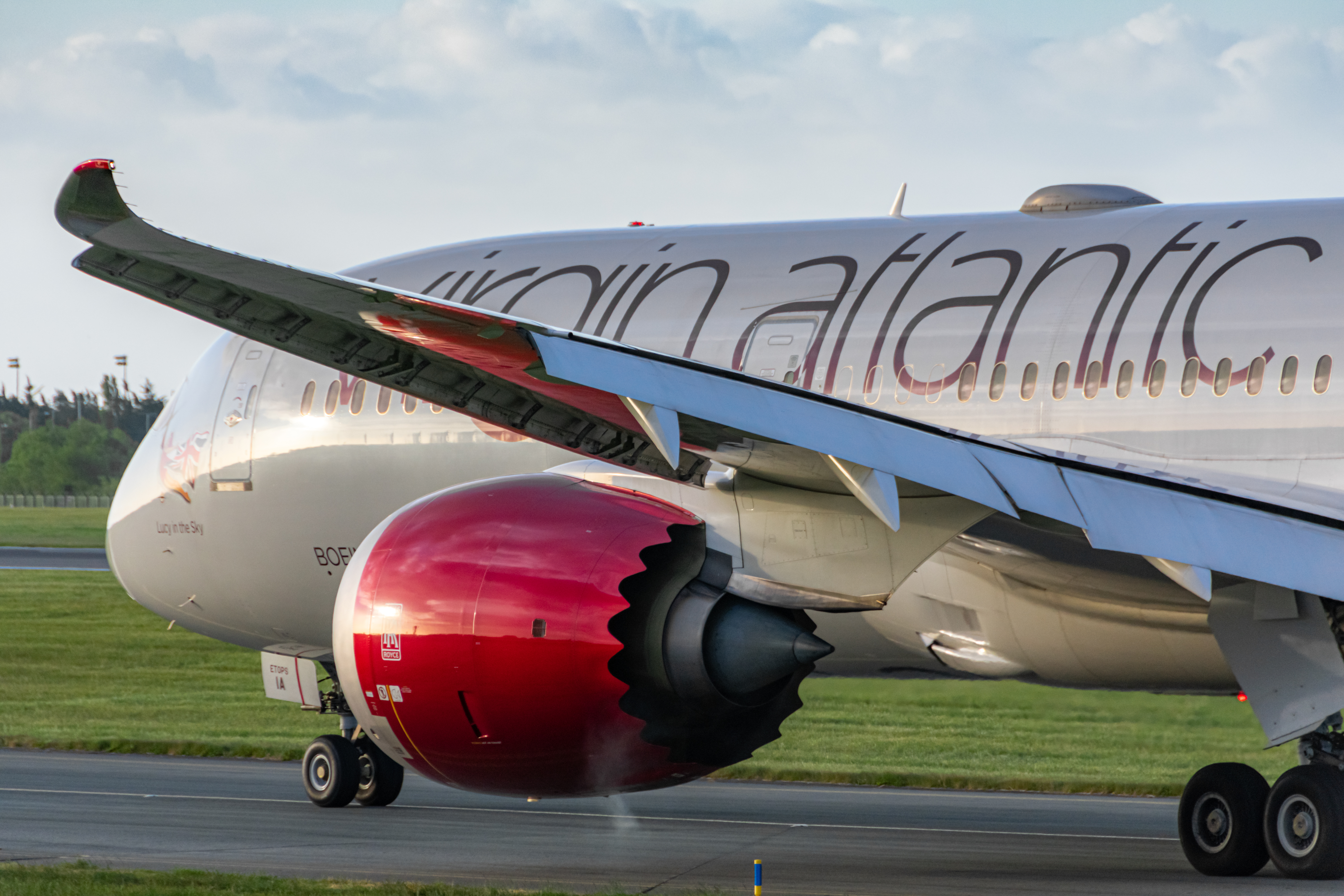 A Virgin Atlantic Boeing 787-9 Dreamliner plane with red turbines