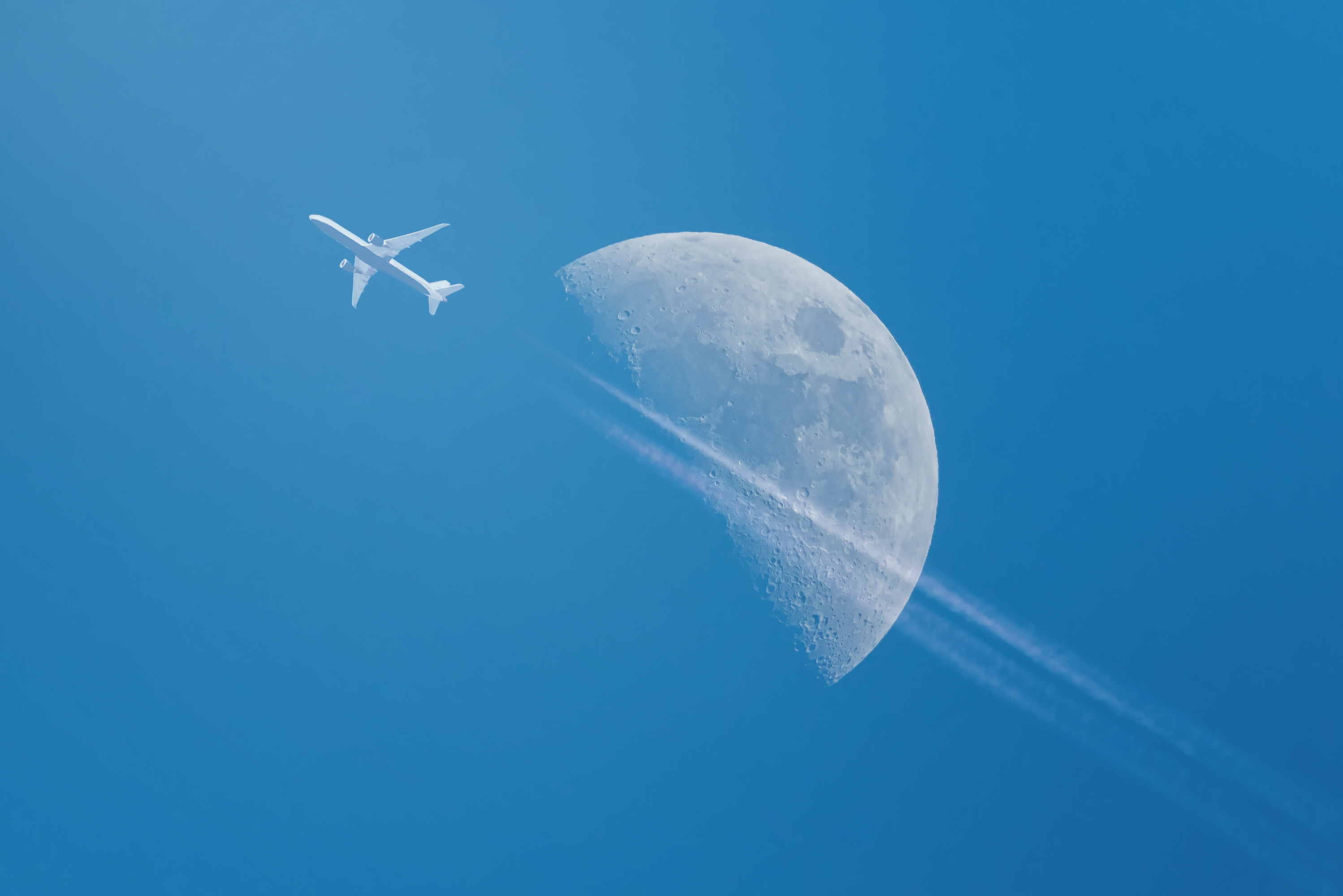 Image of plane flying in front of the moon