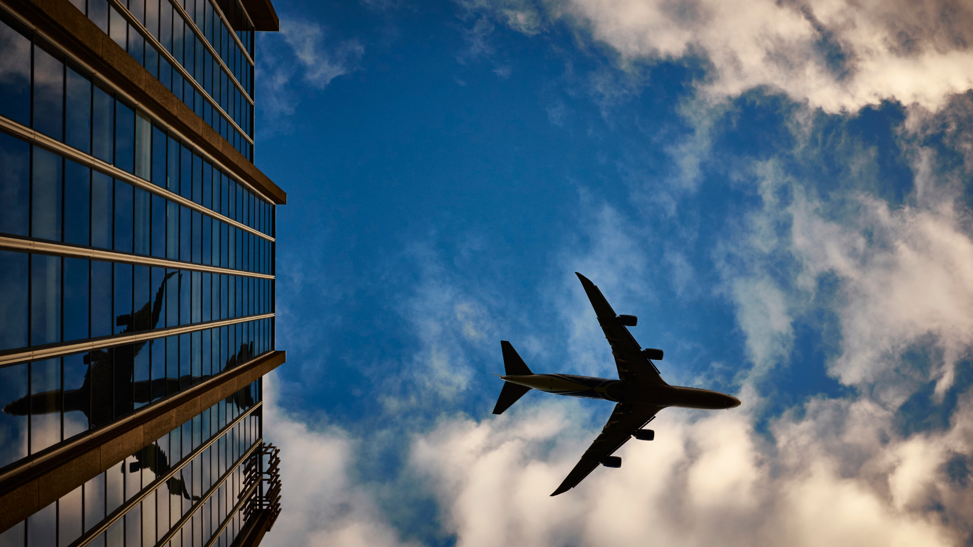 Plane flying in sky over a building